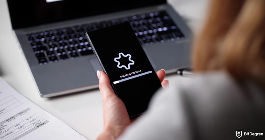 Hardware crypto wallet: a woman installing updates into a device. Hardware crypto wallet: a woman installing updates into a device.